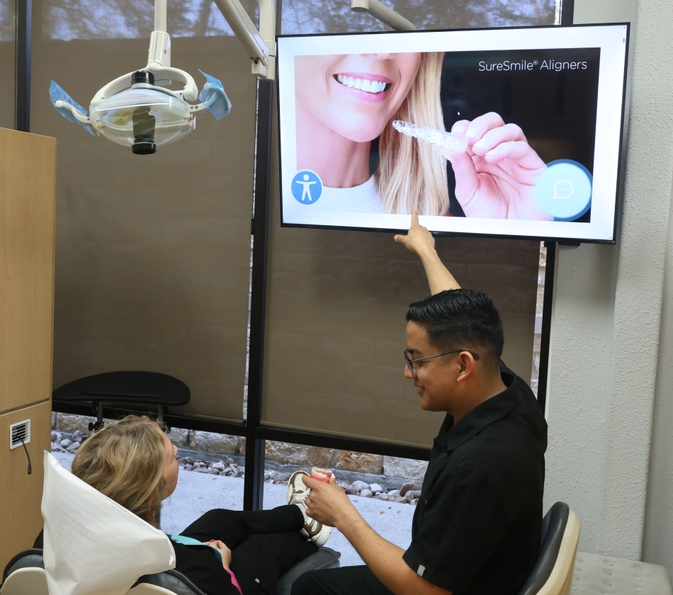 Dentist Dr. Jonathan Phan with patient explaining dental treatment